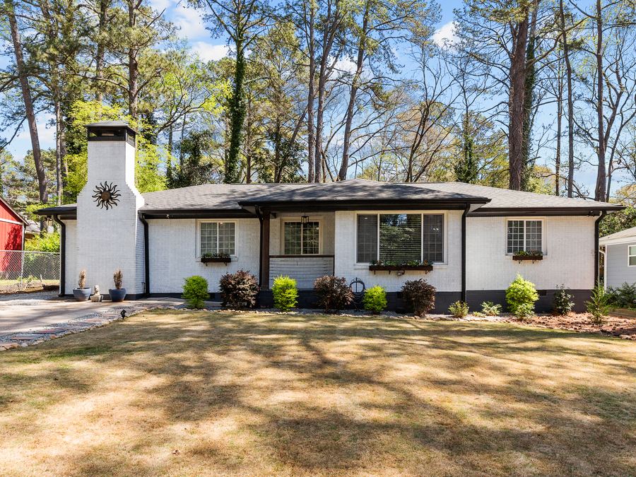 A single-story home with a green front lawn